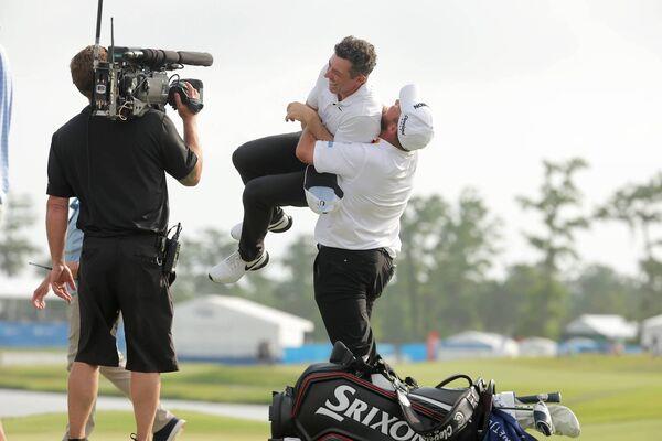 Happy days: Shane Lowry and Rory McIlroy celebrate winning the Zurich Classic of New Orleans at TPC Louisiana in April