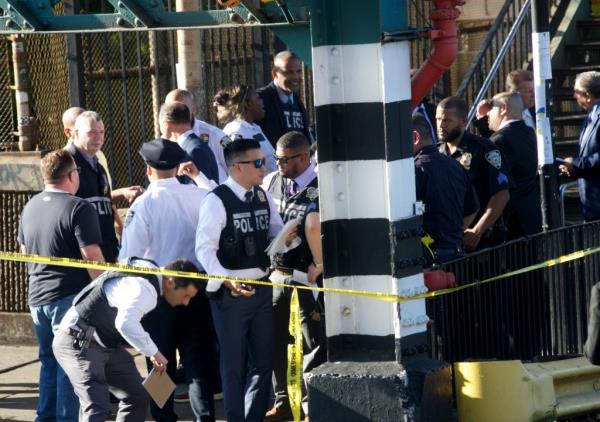 NYPD officers investigate the scene of a shooting on the L train at the Sutter Ave Station in Brooklyn Sunday, Sept. 15, 2024.