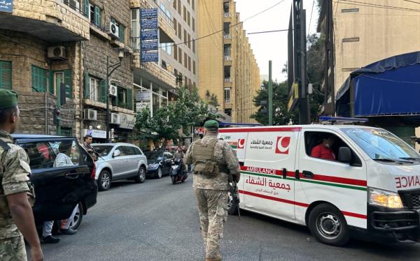 Lebanese army soldiers stand guard as an ambulance rushes wounded people to a hospital in Beirut on September 17, 2024, after explosions hit locations in several Hezbollah stro<em></em>ngholds around Lebanon amid o<em></em>ngoing cross-border tensions between Israel and Hezbollah fighters.