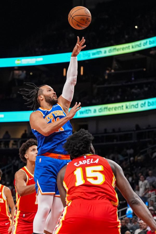 New York Knicks guard Jalen Brunson (11) shoots over Atlanta Hawks center Clint Capela (15) during the first half at State Farm Arena.