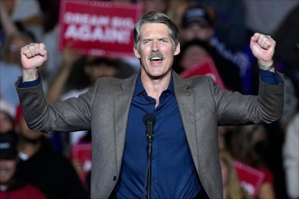 Republican Wisco<em></em>nsin Senate candidate Eric Hovde speaking at a microphone during a 2024 Election campaign event with former President Do<em></em>nald Trump in Milwaukee.