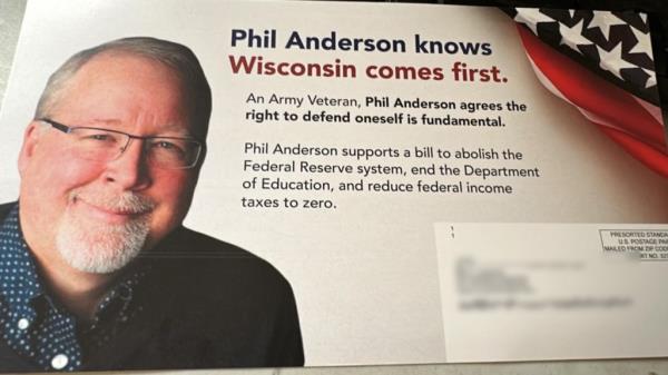 A man with glasses and a beard disavowing mailers appearing to be in favor of his Libertarian U.S. Senate candidature, said to be a tactic used by Democrats in Wisconsin.