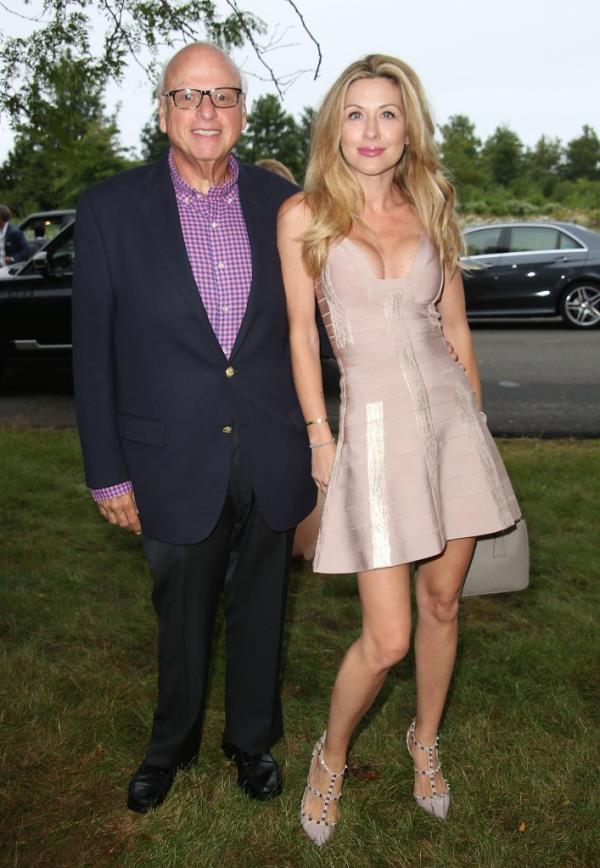 Howard Lorber and Jennine Gourin posing side-by-side at a party in Southampton, New York in 2014.