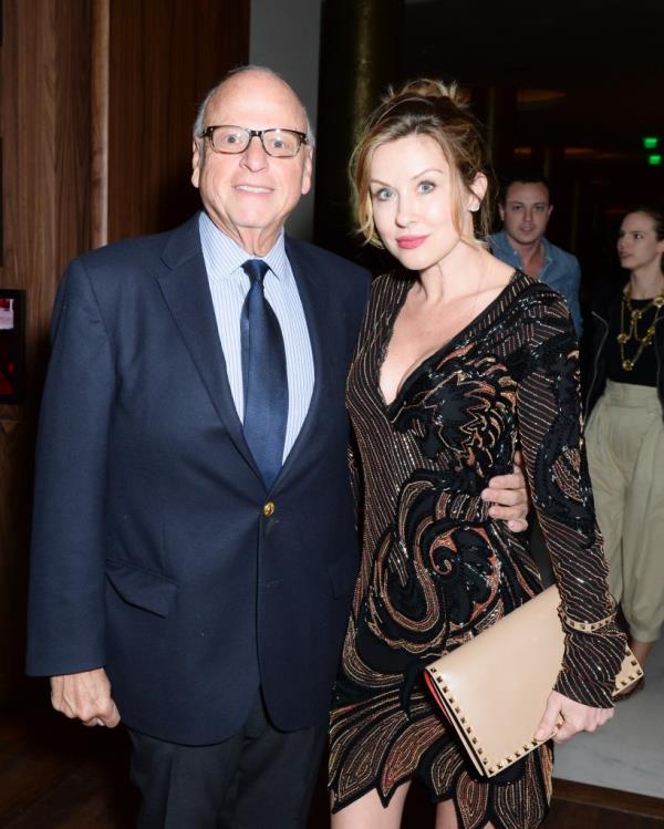 Howard Lorber with arm around Jennine Gourin at event.