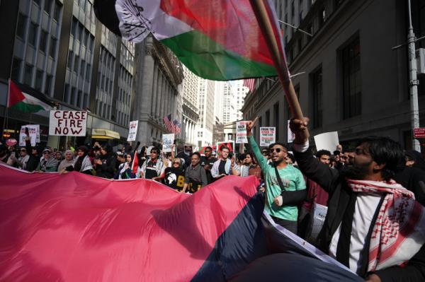 Pro-Palestinian demo<em></em>nstrators protesting with Palestinian flags near Wall Street during the first anniversary of Hamas' October 7 attack on Israel on Monday, October 7, 2024 in New York, N.Y.