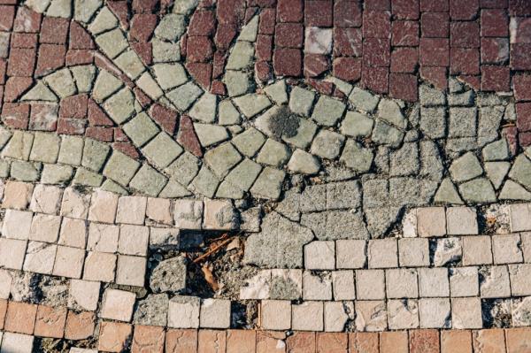 The damaged tile of the mosaic.